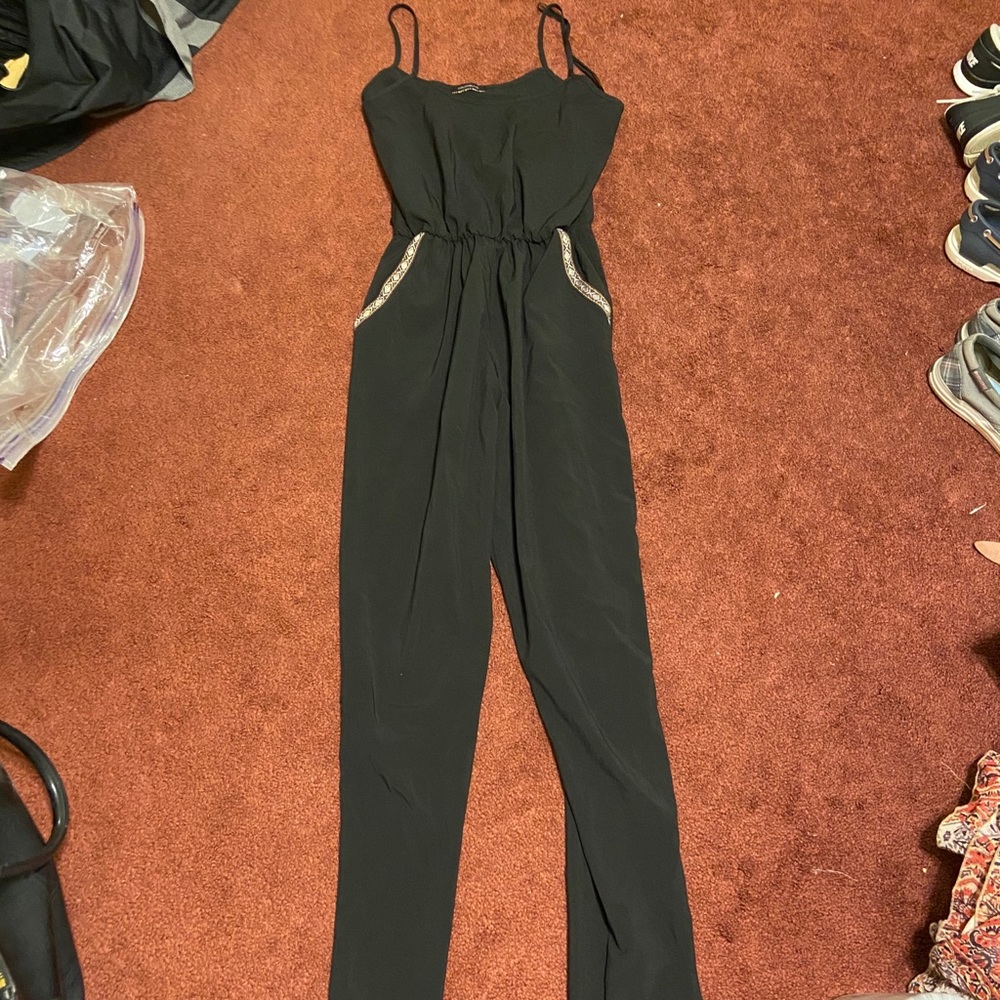 Black jumpsuit with detailed pockets